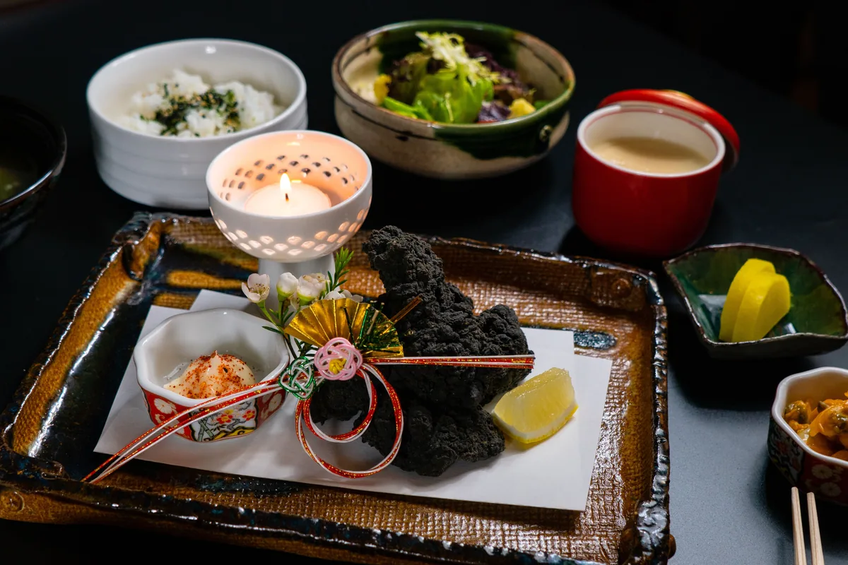 A Japanese course-dinner tray with rice, miso soup and small seasonal dishes, representative image